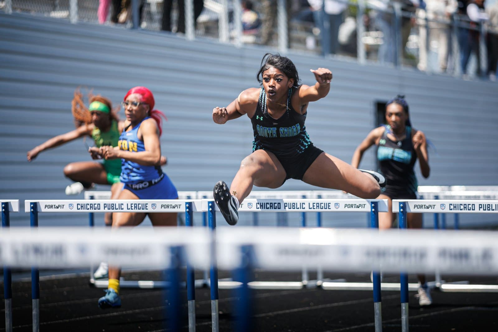 Athlete clearing a hurdle mid-race, motion tracked in real time